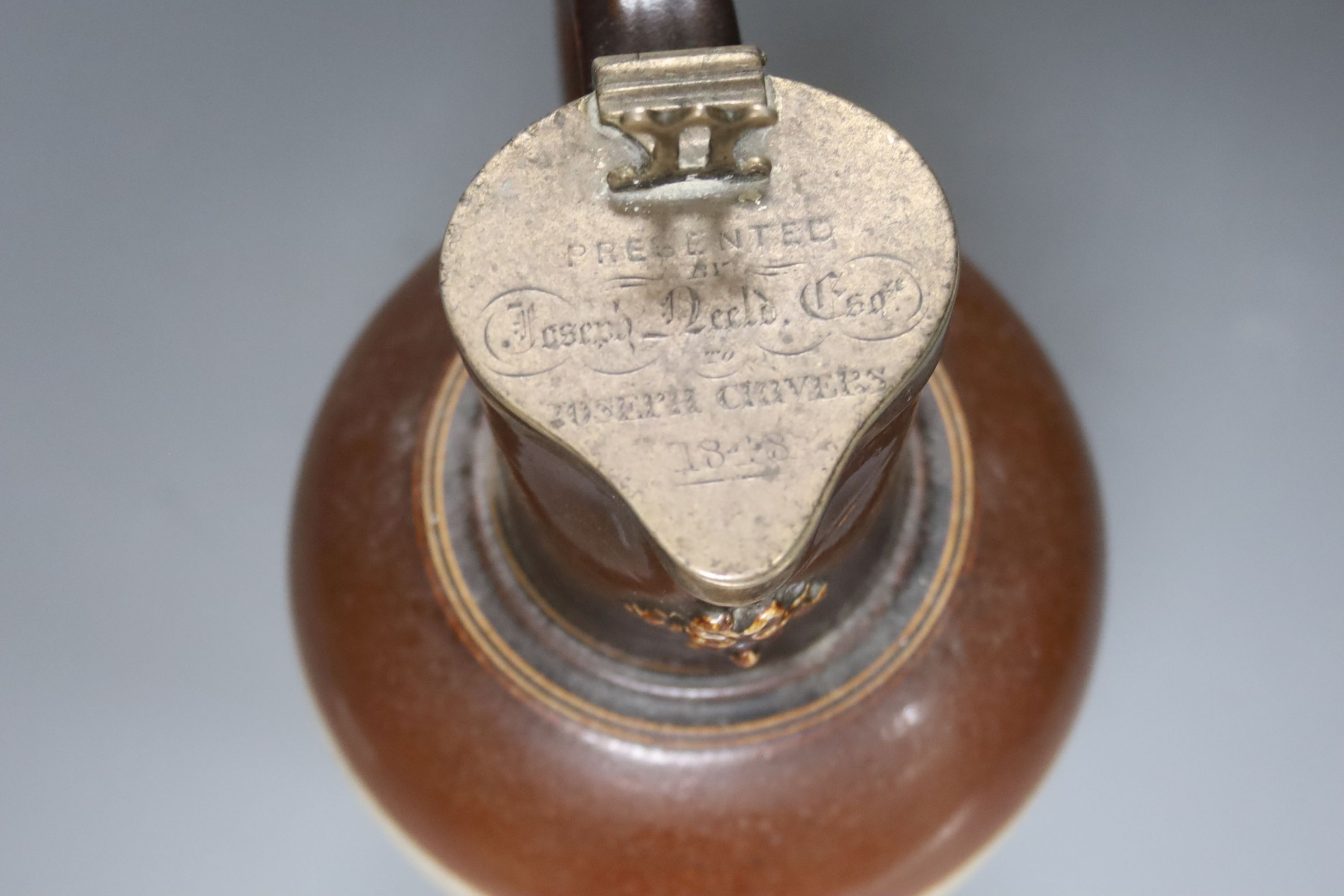 A silver mounted stoneware pitcher ‘presented by Joseph Neeld Esq to Joseph Cirvers 1848’ the base marked ‘Hot water proof’ 26cm